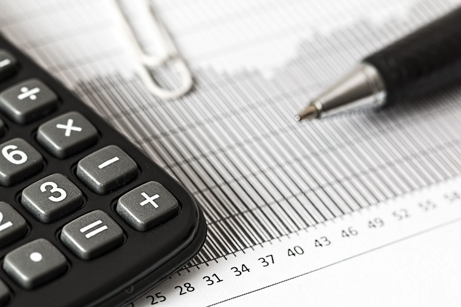 Calculator and pen used to compare borrowing costs