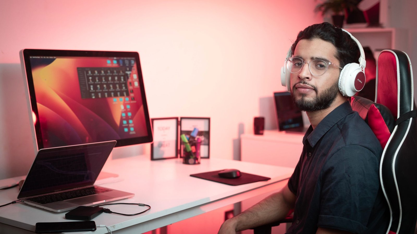 Editing video content with headphones at a home office desk