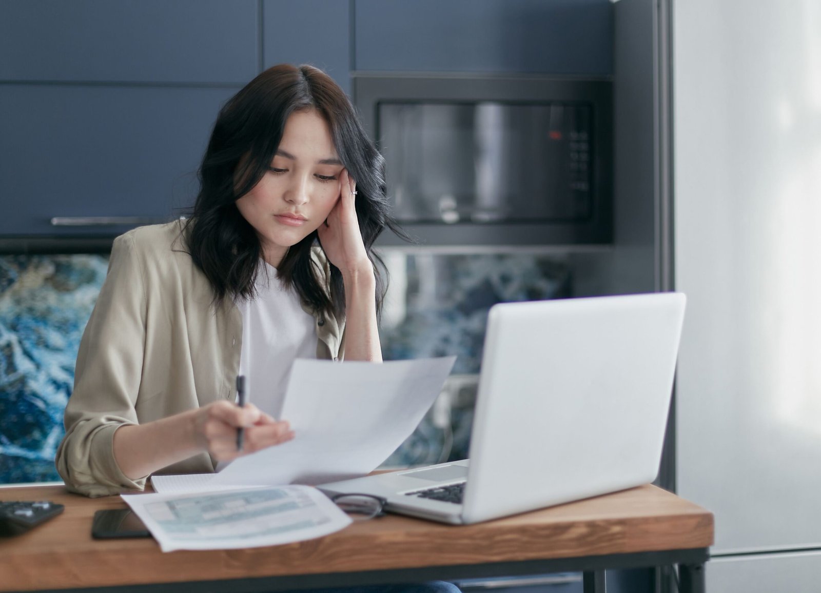 Reviewing retirement account contributions and investment paperwork at home
