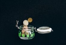 Coins in a savings jar representing capital needed for passive income