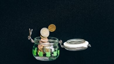 Coins in a savings jar representing capital needed for passive income
