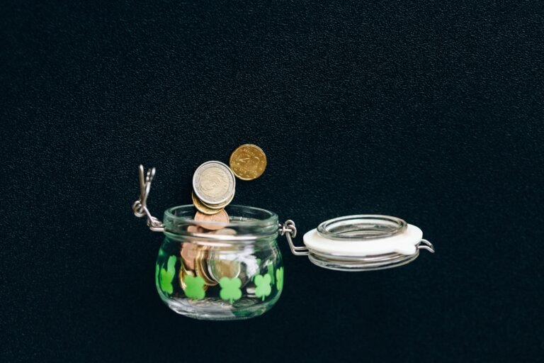 Coins in a savings jar representing capital needed for passive income