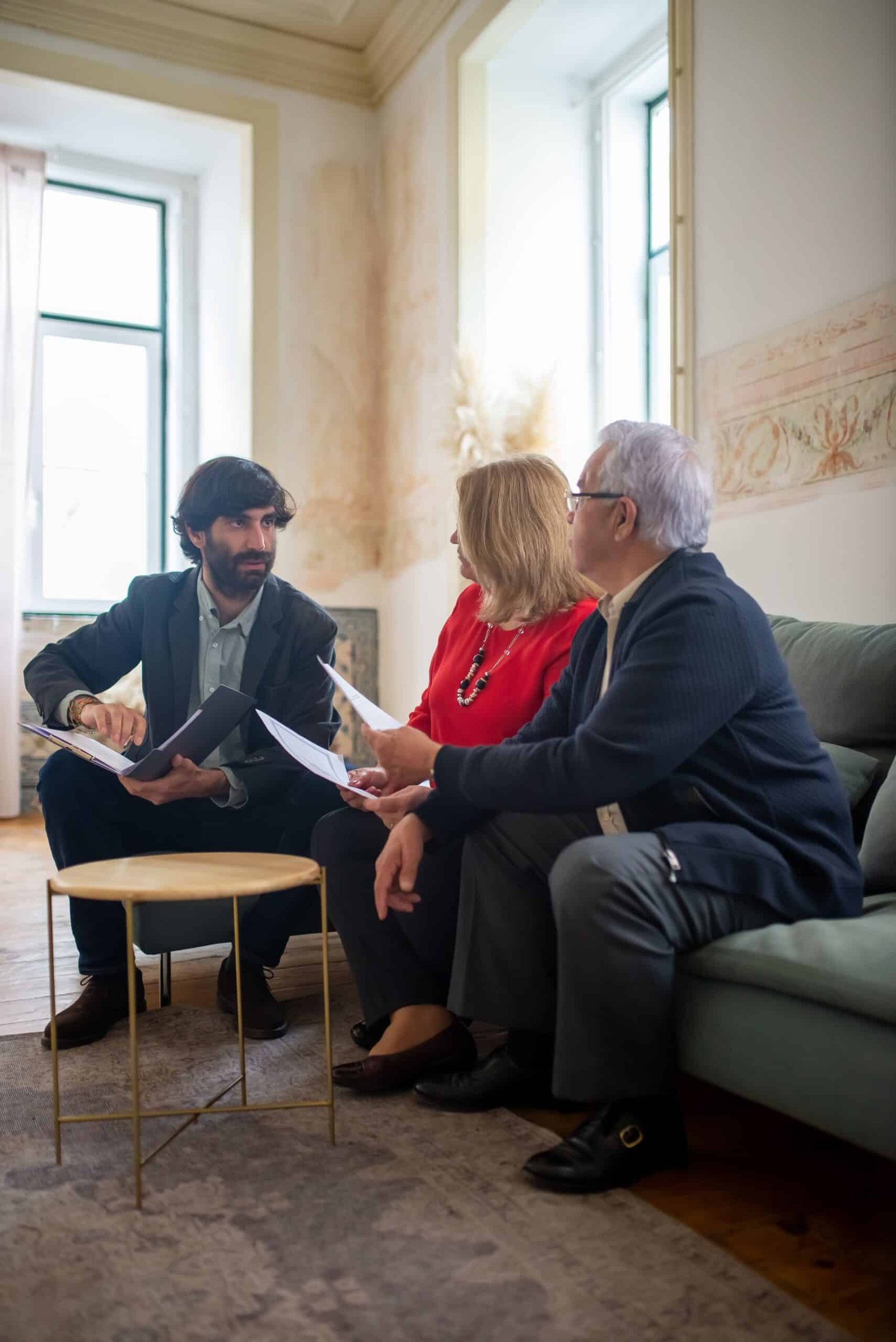 Homeowners comparing mortgage refinance offers with a financial advisor