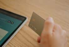 Person holding their first credit card after approval