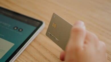 Person holding their first credit card after approval