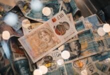 British pound notes representing £1,000 to invest